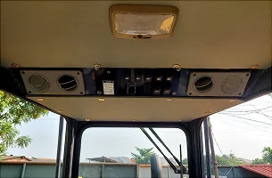 Ceiling-mounted cabin air-conditioning vents and controls.