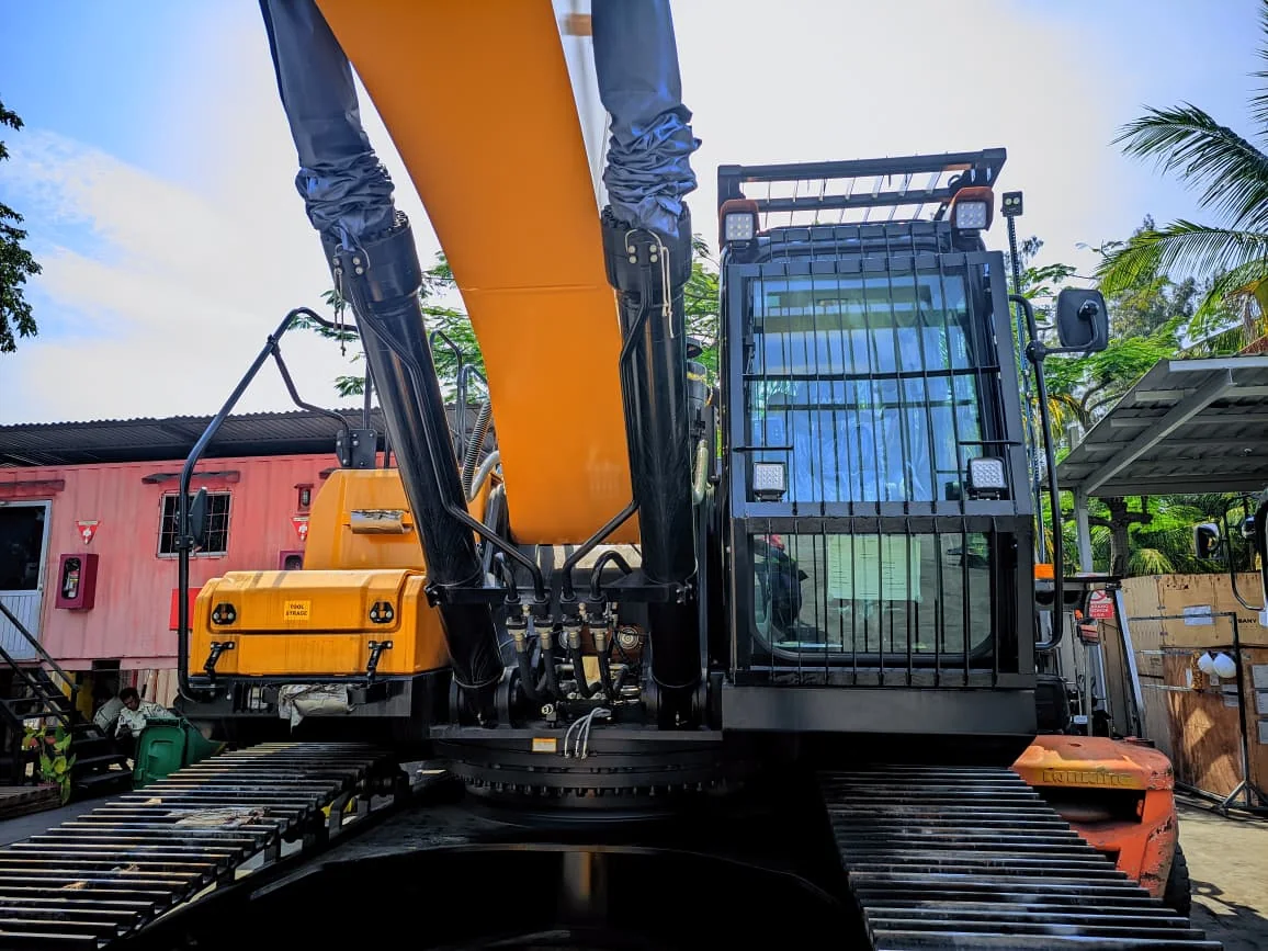 Protective steel guarding around a SANY excavator cabin.